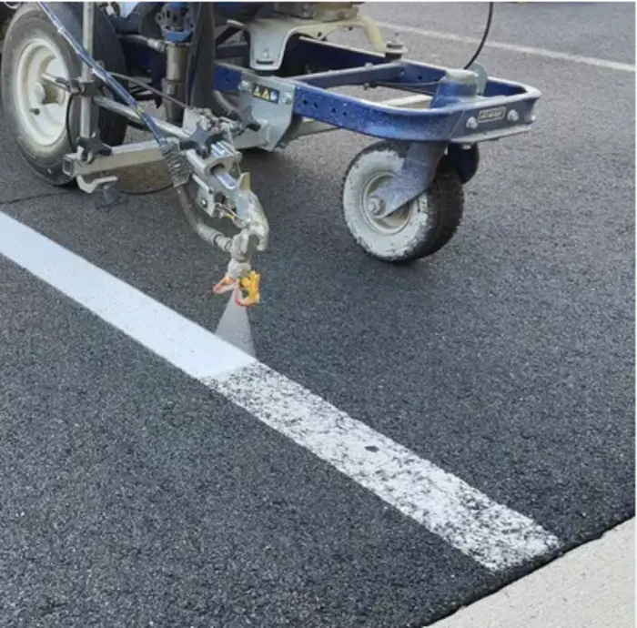 Parking lot re-striping with fresh white pavement lines